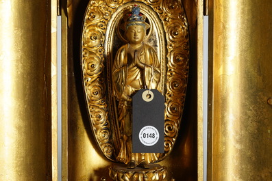 A Japanese lacquered and gilt wood "Zushi" shrine with a standing Buddha on a lotus throne, Edo, 17/18th C.